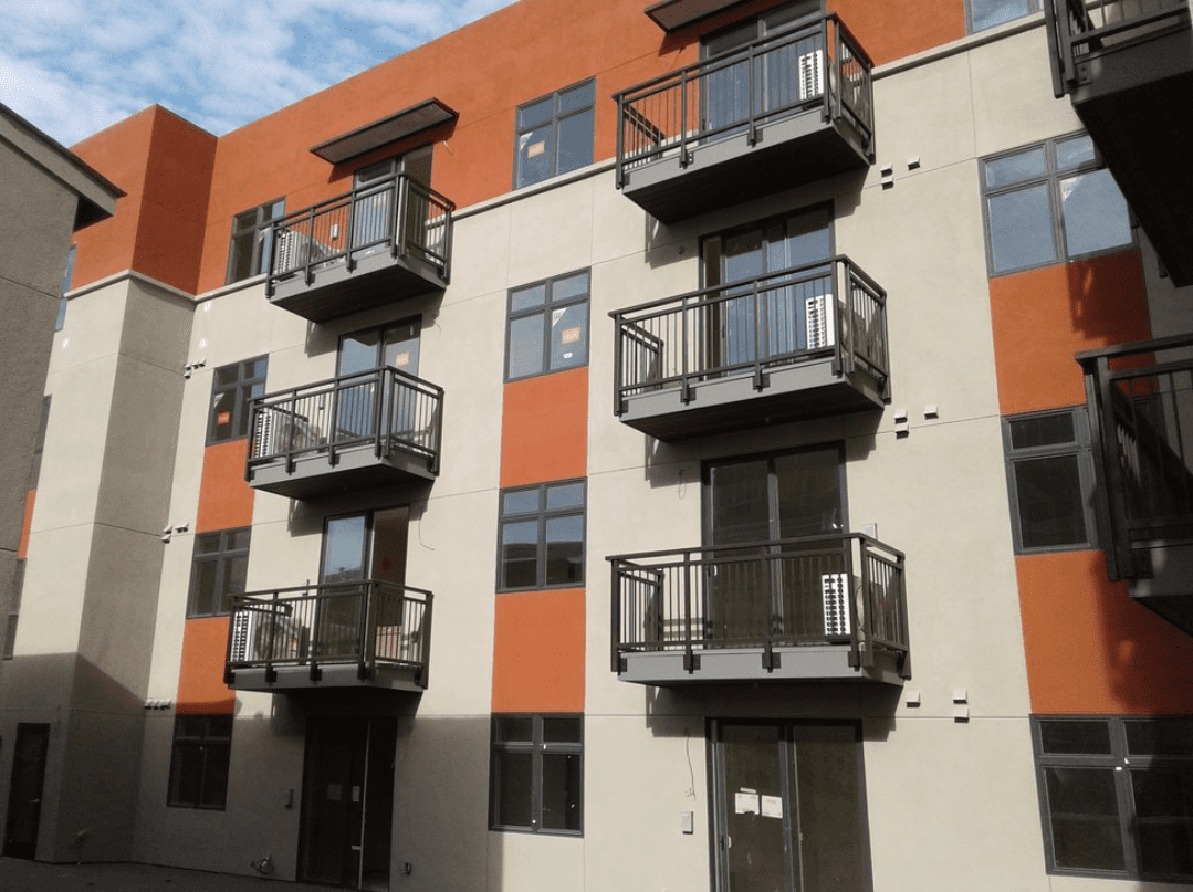 Modern apartment building with balconies and windows.
