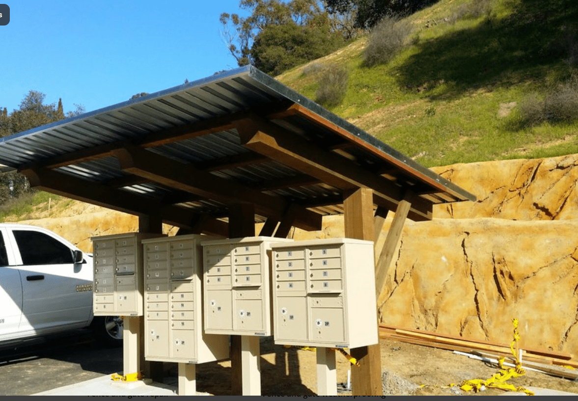 Mailbox shelter with metal roof outdoors.