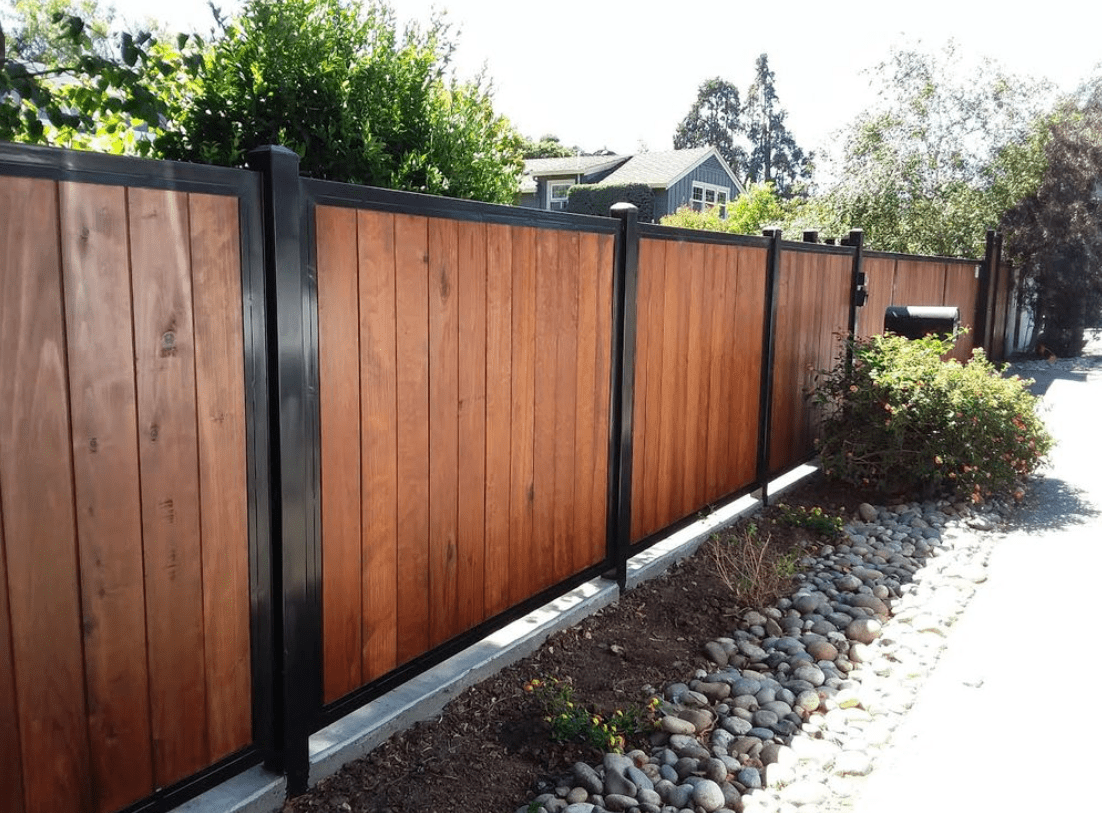 Wooden fence with black metal posts.